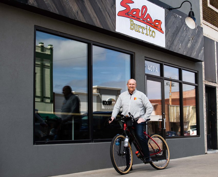 Darrell Pulliam, owner of Brick + Mortar, stands in front of his new restaurant Salsa Burrito with his favorite bike, a Salsa Cutthroat that he has ridden thousands of miles.