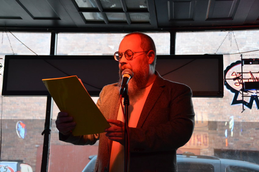 PSU English Professor Chris Anderson reads his poems focused on Kansas during the Open Mic Poetry Reading for WritersFest on Monday at TJ Lelands.