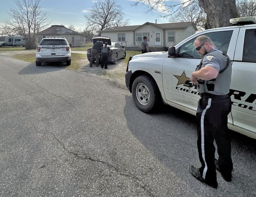 Cherokee County Sheriff&rsquo;s Deputies and investigators prepare to leave a residence after apprehending fugitive James Paul Eric Thompson Wednesday, March 29.