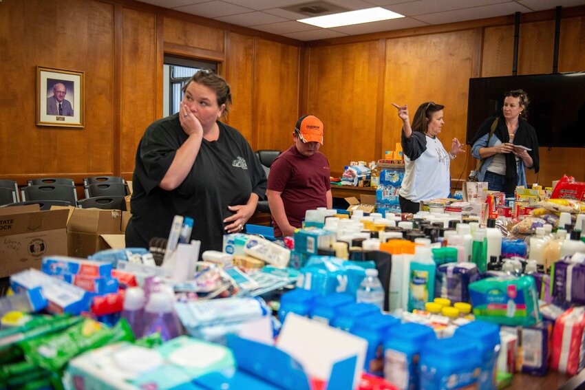 People browse through donated goods inside city hall in Adamsville, Tenn., on Sunday, April 2, 2023.