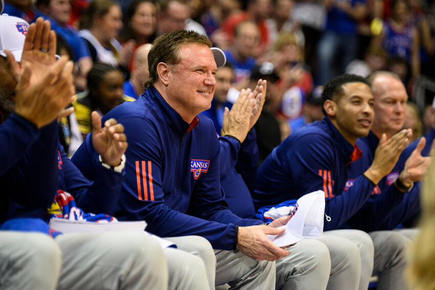 Kansas head coach Bill Self listens as Kevin McCullar Jr. gives a speech on Senior Night after they clinched a share of the Big 12 regular-season championship with a win over Texas Tech in an NCAA college basketball game in Lawrence, Kan., Tuesday, Feb. 28, 2023. (AP Photo/Reed Hoffmann)