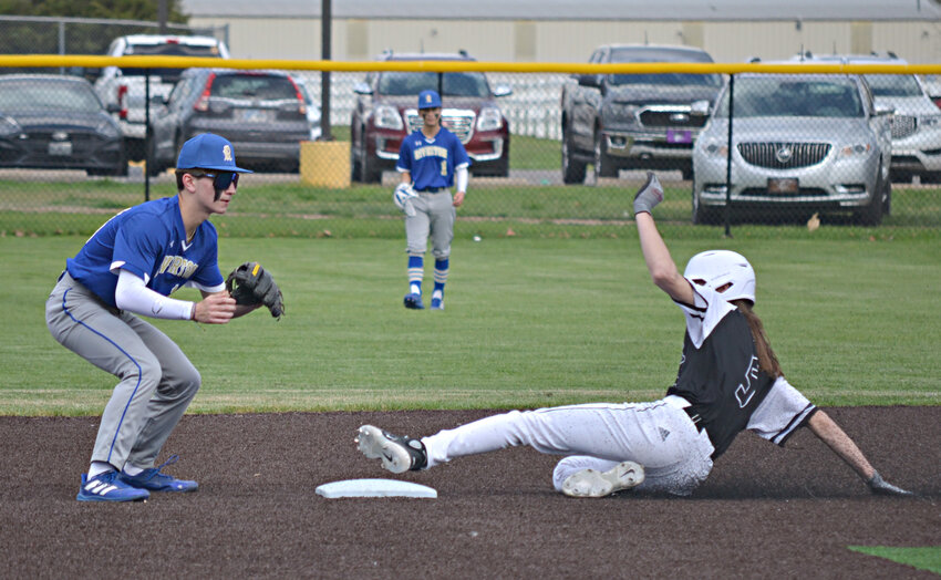 Frontenac's Bryant Kitchen Slides Into second during the Raiders win over Riverton on Monday in Frontenac.