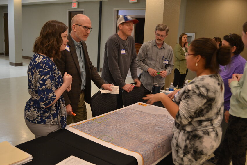 Residents of the northeast sector of Pittsburg gather around a map to discuss neighborhood boundaries as citizens see them. Many neighborhoods are easily delineated, such as housing developments, others are more nuanced, relying on main streets and prominent landmarks to identify them.