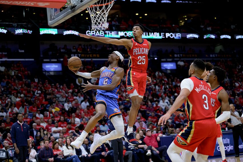 Oklahoma City Thunder guard Shai Gilgeous-Alexander (2) shoots against New Orleans Pelicans guard Trey Murphy III (25) during the second half of their NBA play-in tournament game Wednesday night in New Orleans. (AP Photo/Matthew Hinton)