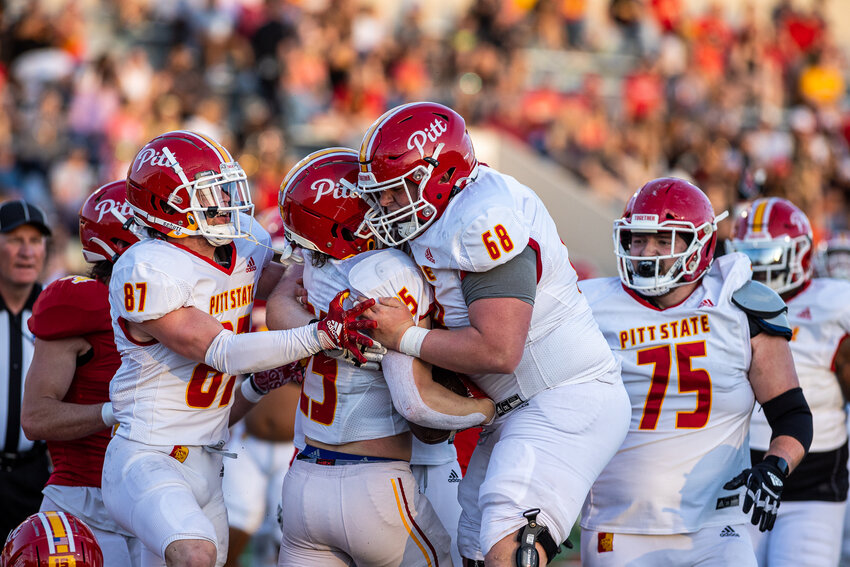 Evan Taylor (68) and Jake Bogdon (87) congratulate Adam Albertini after his 14-yard touchdown run in Pittsburg State's spring football game Friday night at Carnie Smith Stadium. COURTESY DEREK LIVINGSTON / PSU SPORTS INFORMATION DEPARTMENT