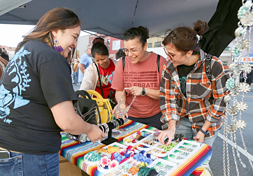 Nely Rojo, Sylvia Bevilacqua and Carmen Belew stop by Laura Medina&rsquo;s booth, Lau&rsquo;s Stylish Bags, at Pittsburg ArtWalk on Friday.