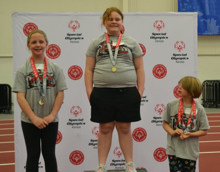 Fort Scott Tiger Piper Wolf, center, beat out fellow Tigers Paisley Crimby, left, and Sarah Hatfield, right, in the Turbo Javelin event at Thursday's SEK Special Olympics.
