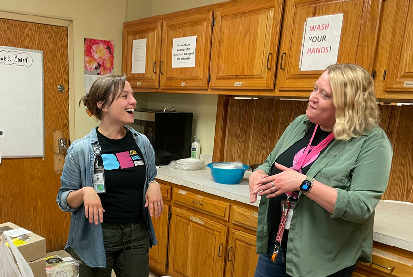 (From left) Leah Gagnon, executive director of Wesley House and director of patient engagement at CHCSEK, and Abby McCoy, projects coordinator, converse with one another while in the kitchen at Wesley House.