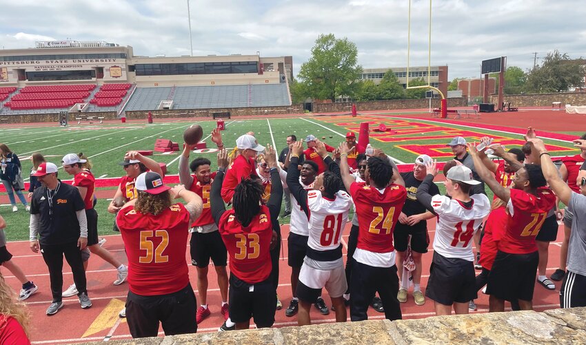 Members of the Pitt State football team form a tunnel for participants to go under at the end of Victory Day on Friday.
