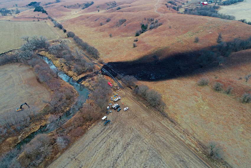 In this photo taken with a drone, cleanup continues in the area where the ruptured Keystone pipeline dumped oil into a creek in Washington County, Kan., Dec. 9, 2022. A report for U.S. government regulators released online Monday, May 15, 2023, says design issues and lapses in operations and the oversight of construction for a bend in a pipeline led to the massive oil spill on the Keystone pipeline system in northeastern Kansas.