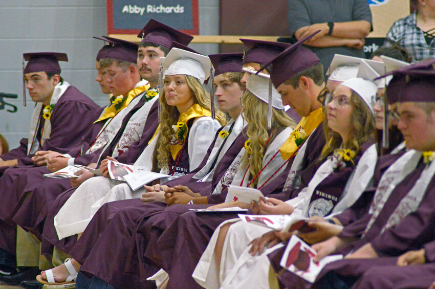 Graduates listen to Paige Osburn's valedictory address during the commencement ceremony at Northeast High School.