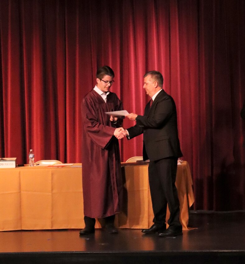 GHS senior Jaxson Robinson is awarded a Certificate of Merit by principal Todd Ferguson for being a finalist in the National Merit Scholarship Competition Friday, May 12 in John E. Shireman Auditorium during the Senior Awards ceremony. Eighty-three students attended the celebration and were recognized for their achievements and awarded scholarships.