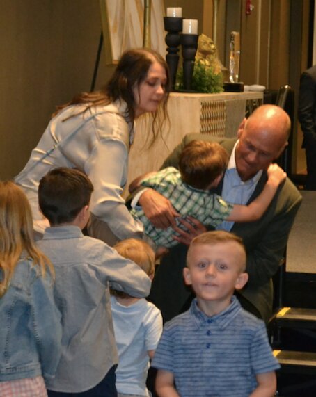 Jeff Elliott embraces his family after receiving the Pittsburg Chamber of Commerce Spirit of Pittsburg Award from his father, Gordon, a 2010 recipient.