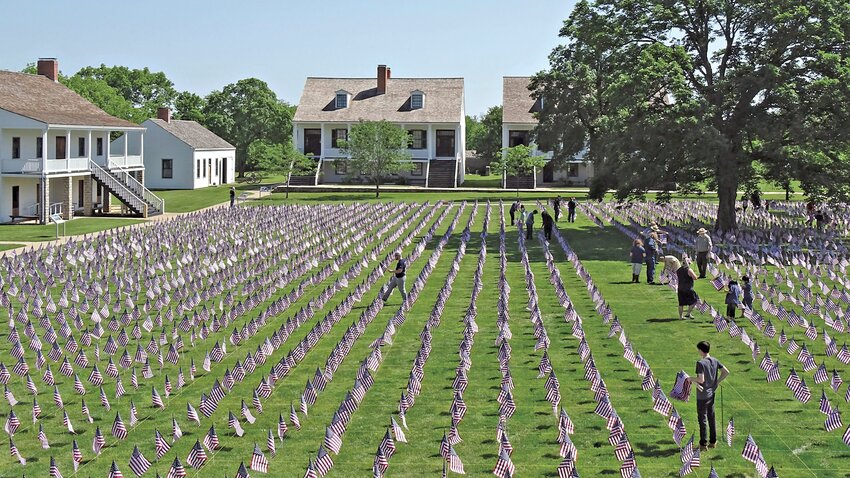 Staff and community members set up the Field of Honor in 2022.