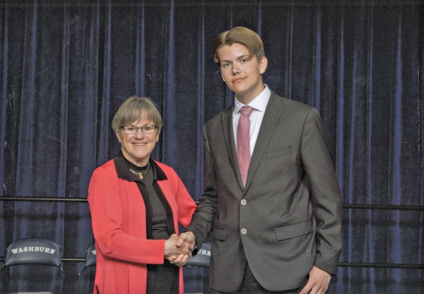 Jaxson Robinson (right), a Girard High School student from Pittsburg, shakes hands with Kansas Governor Laura Kelly during the 40th Annual Governor&rsquo;s Scholars Awards Program May 7 in Topeka. The ceremony honored the top academic one percent of Kansas high school seniors.
