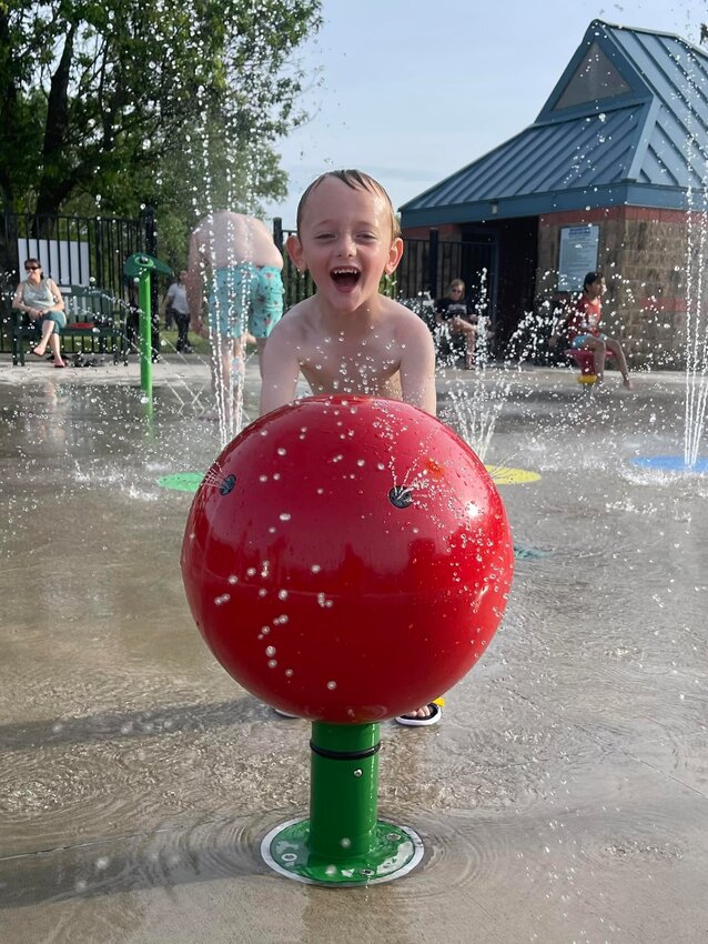 A child plays at the Schlanger Park Splash Pad in Pittsburg.