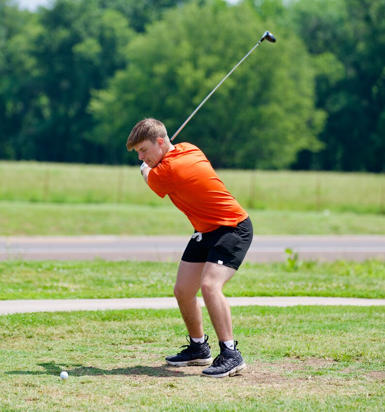 Girard native Taylor Bruning concentrates as he delivers a hit on the first hole at Crawford Hills Golf Couse in Girard at the third annual Girard Area Community Foundation Charity Golf Tournament on Saturday.