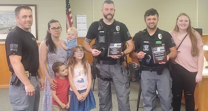 Frontenac Police Chief Cody Milligan (left) with Officers Andrew D&rsquo;Alfonso (center) and Jesse Spencer (right) with their families. The two officers went above and beyond to save the life of an unresponsive 3-month-old baby on May 2, 2023.