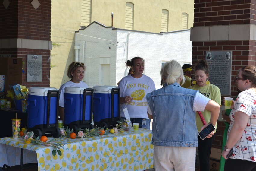 Pittsburg residents enjoy a cool cup of lemonade at the Pritchett Pavillion on Tuesday, supporting research to find a cure for children&rsquo;s cancer.