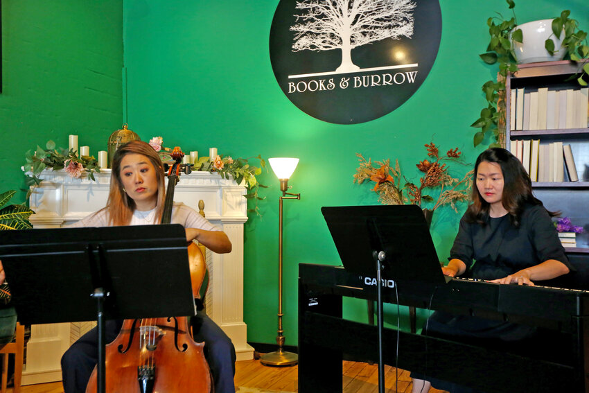 Cellist Dr. Hyerim Mapp, left, and pianist Dr. Soojin Jin, right, perform &ldquo;Romance in F major Op. 36&rdquo; by Camille Saint-S&auml;ens at Books &amp; Burrow Bookstore Friday afternoon to open the sixth day of the Pittsburg Festival of the Arts. Mapp, a former Pittsburg State University music faculty member, and Jin, an international sensation, played a program of short romantic works that featured pieces from Fr&eacute;d&eacute;rich Chopin, Gabriel Faure and Robert Schumann.