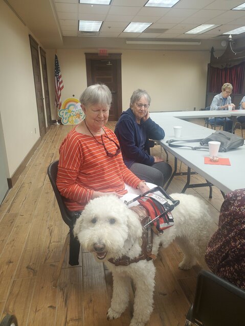Poppy, a full Poodle, enjoys Third Tuesday Book Club at the Pittsburg Public Library's with his owner and friends.