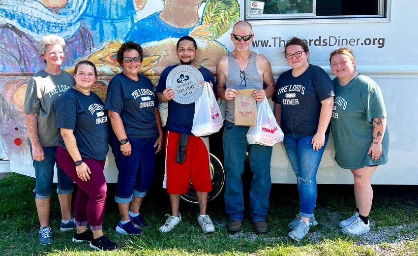 From left are Rhonda Brisendine, Anna Oberle, Laura Ramsey, Jeremy D., Johnnie Butes, Maggie Postier and Hailey Goodrich after The Lord&rsquo;s Diner served its 500,000th meal on Wednesday in the parking lot of the Knights of Columbus Hall.