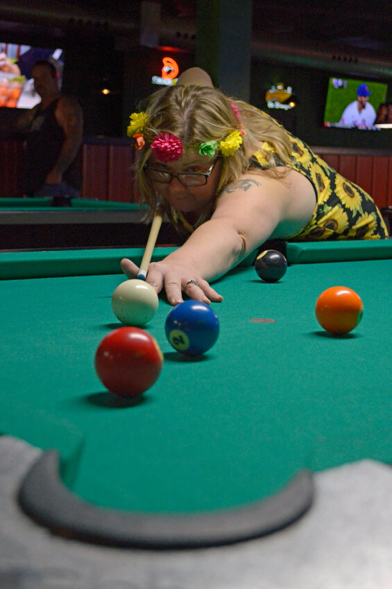 Ilene Storm, with Backyard Discovery, takes a shot during the Corporate Challenge&rsquo;s championship pool game Wednesday, Aug. 9 at Opie&rsquo;s Pizza.