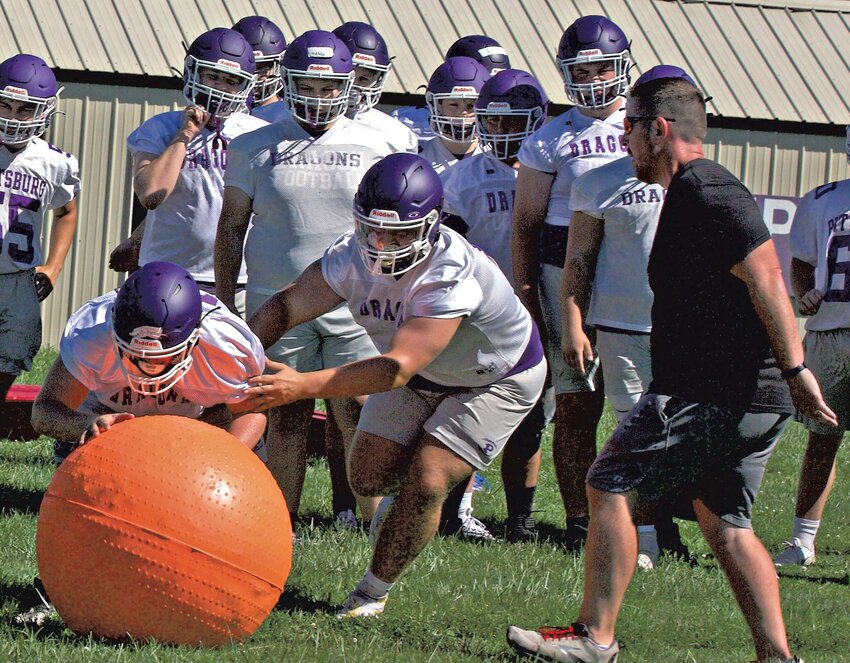 Pittsburg linemen participate in a drill on the first day of practice Monday at the high school practice field.