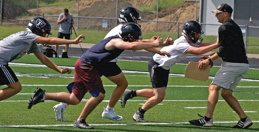Frontenac players block head coach Mark Smith during a drill at Tuesday&rsquo;s practice.