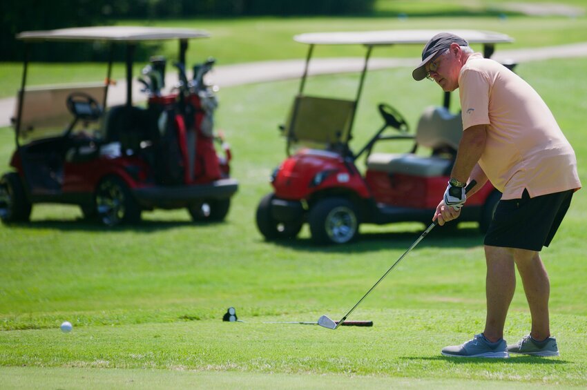 Mike Doue powers the golf ball onto the green with his wedge club during the 21st annual Girard Medical Center Foundation Summer Golf Classic held Saturday at Crawford Hills Golf Course.