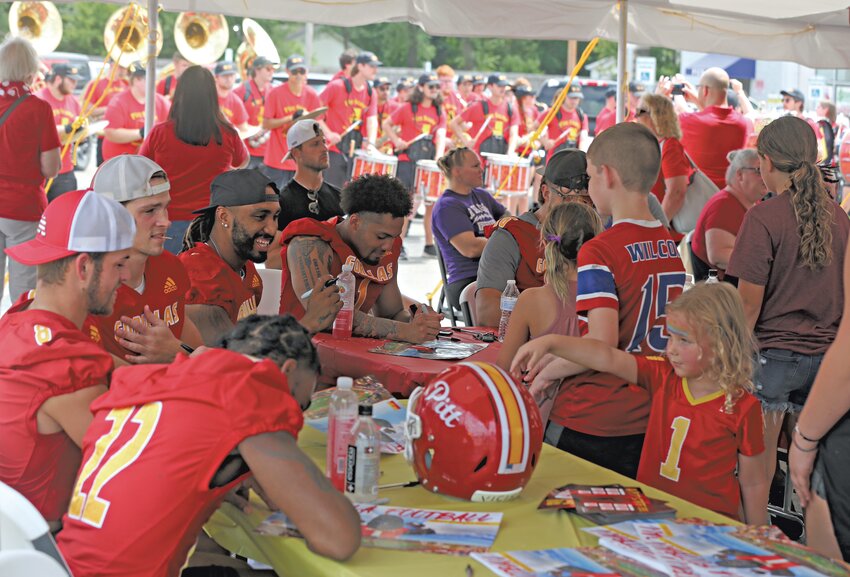Pittsburg State football players sign autographs, while the Pride of the Plains Marching Band, Pitt Cheer and the PSU Crimson &amp; Gold Dance Team provide entertainment Saturday during the inaugural Kid&rsquo;s Festival in the Ron&rsquo;s Supermarket parking lot. The four-hour event also included a bounce house, obstacle course, face painting and food. The first 300 kids 12-under received a special edition poster to be signed by the PSU football players. The Gorillas, ranked fourth in NCAA Division II, open their 2023 season Thursday at home against MIAA rival Washburn.