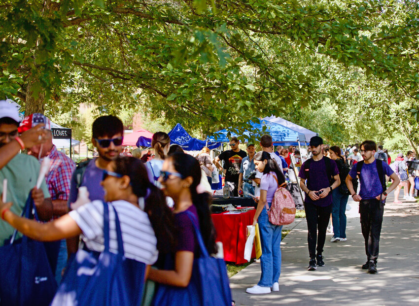 Students walk around The Oval at Pittsburg State University&rsquo;s campus for the annual Community Fair on Tuesday, which featured area businesses and organizations.