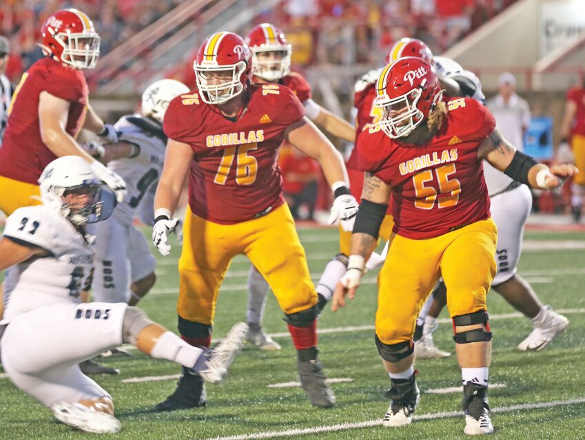 Pittsburg State offensive linemen Drew Daniels (76) and Zane Madison (55) turn Washburn defensive tackle Chase Ast into a blur during the Gorillas&rsquo; 34-7 win last Thursday at Carnie Smith Stadium.