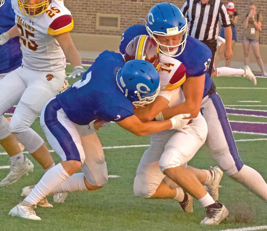 Colgan defenders Connor VanBecelaere (3) and Tristan Voss (52) tackle Girard senior quarterback Jake Towner for a short gain Thursday at Hutchinson Field.