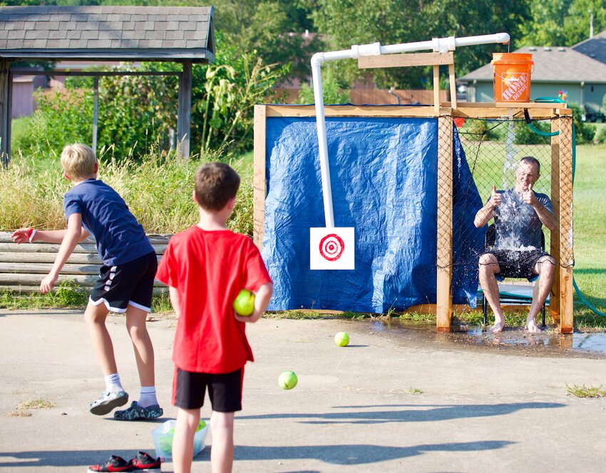 An attendee at Wednesday&rsquo;s Back 2 School Bash, hosted by First Christian Church in Pittsburg, hits a bullseye on the dunk tank target as several kids showed off their arm during the event.