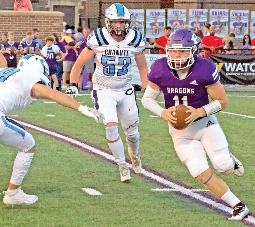 Pittsburg senior quarterback Tucker Akins keeps the football and seeks positive yardage in the first half Friday night against Chanute at Hutchinson Field.