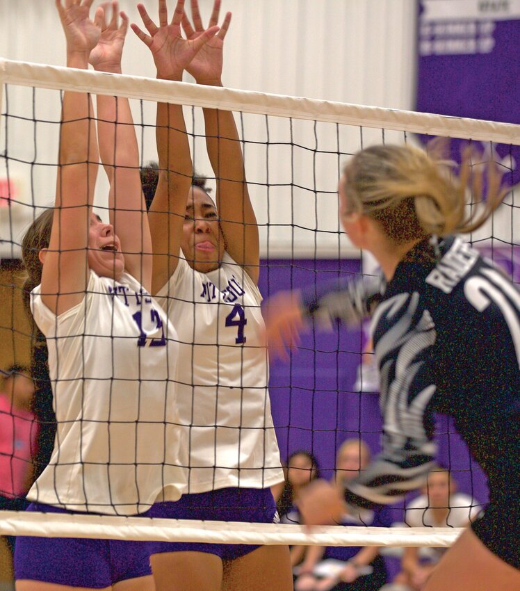 Pittsburg defenders Heather Mowdy (13) and Onna Jorge (4) attempt to block the shot of Frontenac&rsquo;s Lucy Anderson during their match Thursday night at Pittsburg High School.