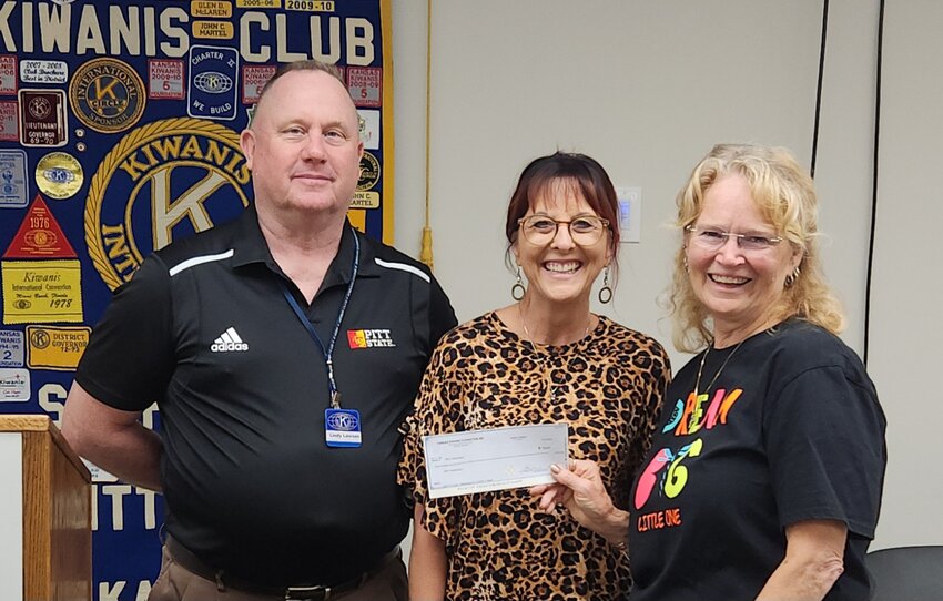 Lindy Lawson (left), president of the Pittsburg Sunflower Kiwanis Club, and Kiwanis member Debbie Hurt Walker (right) awarded the Kansas Kiwanis Foundation grant of $500 to Tess Watson, founder of Dream Big Little One, during a recent Kiwanis meeting. Dream Big Little One is a non-profit organization which seeks to provide beds for children in need in the area and the surrounding communities. Before the meeting started, Walker also presented Watson with a trunk load of handmade pillowcases, quilts, bedding, and stuffed animals &mdash; much of it made by the ladies in the Little Balkans Quilt Guild.