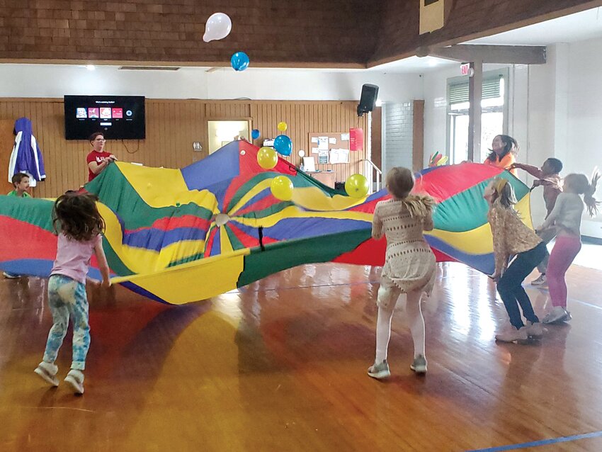 Children play with a parachute at last year&rsquo;s Camp Now &amp; Then at the Lincoln Center, which begins Monday as it offers an opportunity for kids to play games, create crafts and make new friends.