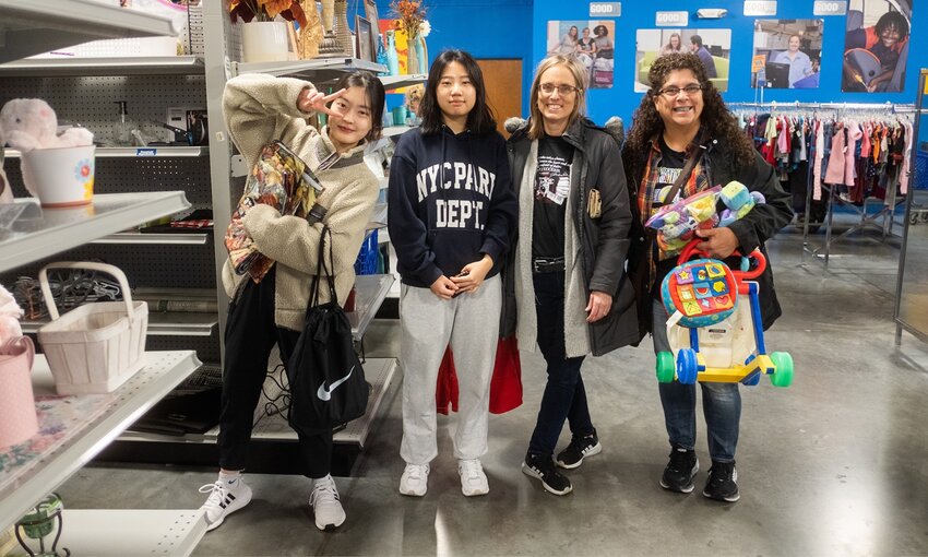 Angela Martino-Lewis (right) takes PSU international students shopping at a thrift store. Lewis has served as a host to many international students, and has participated in Pitt State&rsquo;s Friendship Family program since 2018.