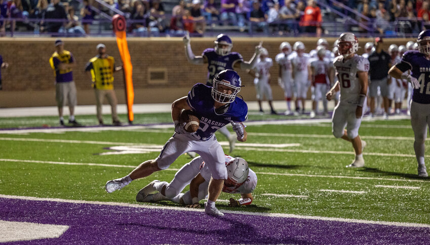 Pittsburg&rsquo;s Wyatt Rink scores one of his four touchdowns in the Purple Dragons&rsquo; 32-22 victory over Fort Scott on Friday night at Hutchinson Field.