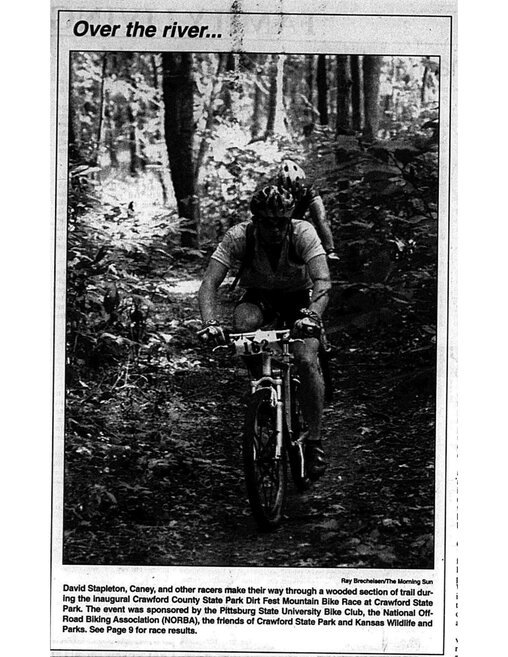 David Stapleton, Candy, and other racers make their way through a wooded section of trail during the inaugural Crawford County State Park Dirt Fest Mountain Bike Race at Crawford State Park. The event was sponsored by the Pittsburg State University Bike Club, the National Off-Road Biking Association (NORBA), the friends of Crawford State Park and Kansas Wildlife and Parks.