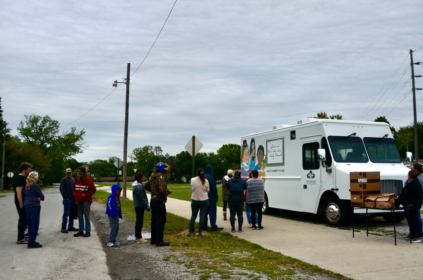 Area residents gather outside Wesley House waiting for the Lord&rsquo;s Diner food truck to open up on Friday. From 3 to 3:45 p.m., the food truck also makes stops at The Knights of Columbus Towers and Stilwell Apartments located at 700 N. Pine and at Demarus Park, located at 16th and N. Michigan.