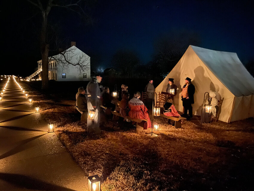 Reenactors remain in first-person telling stories of the fort during the candlelight tour.&nbsp;