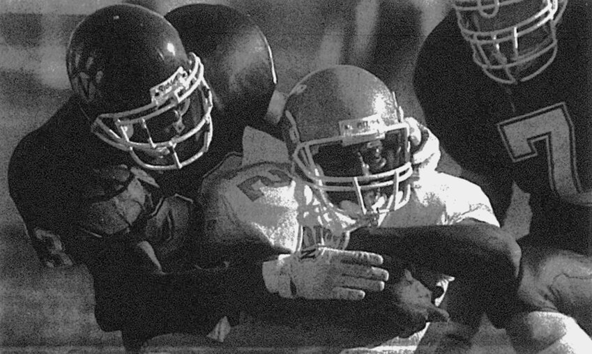 Northwest Missouri State&rsquo;s Twan Young (23) and Aaron Crowe (7) converge on Pittsburg State&rsquo;s Lateef&nbsp; Walker during the 23-18 win by the host Bearcats in Maryville, Mo., October 25, 1998.