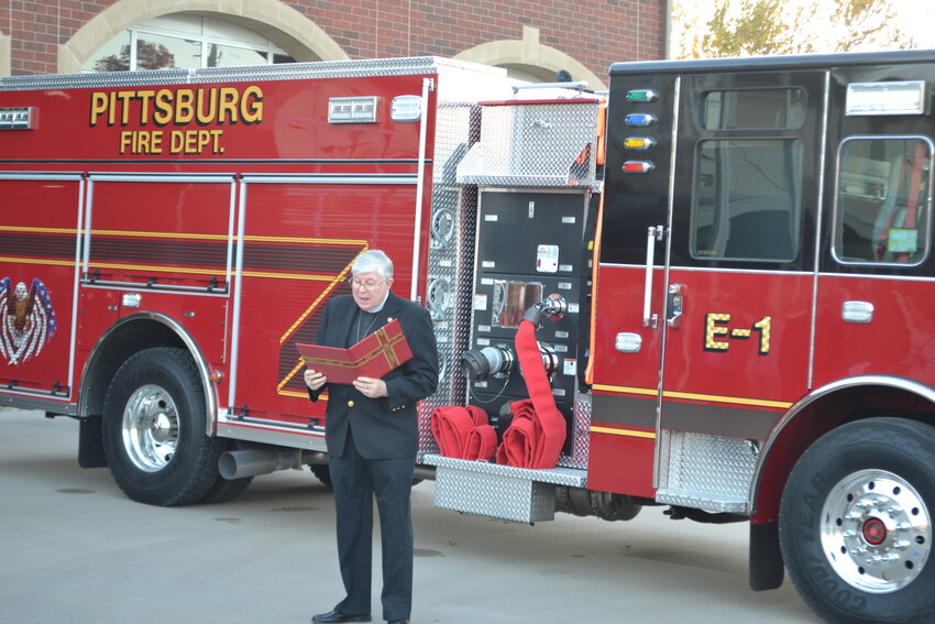 Fire Department Chaplain Mark Chambers blesses the new fire engine outside Station One during the Push In Ceremony in Pittsburg Tuesday evening.