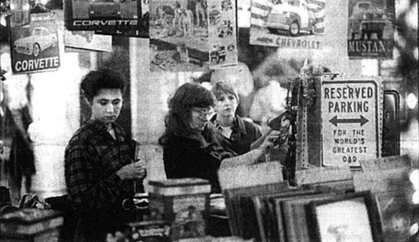 Nancy Harry, center, owner of Nancy&rsquo;s Unique Gifts kiosk at Meadowbrook Mall, looks for an item for customers Brandy Rhoades, left, and Georgia Rhoads. Shopper filled local streets, malls, and shops Friday on what is traditionally the busiest shopping day of the year.&nbsp;