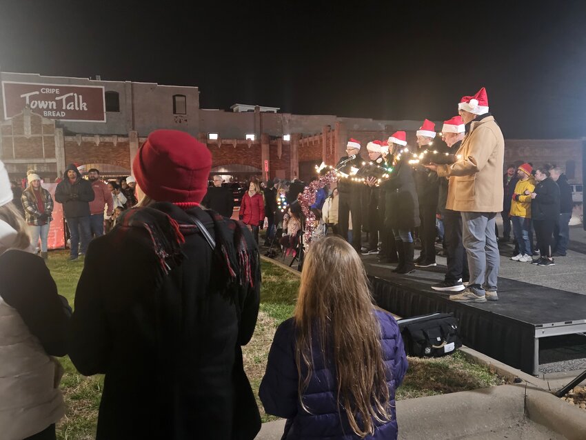 After the tree was lit up, members of the Pittsburg Noon Rotary led the crowd in Christmas carols and songs while Ron&rsquo;s Supermarket served cookies and hot cocoa Saturday night at the Pritchett Pavillion.