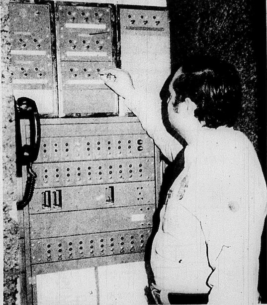 Police dispatcher Mike Murry resets a false alarm on at the signal board at the Pittsburg Police Station. An alarm sounds and sets off a light on the bard to designate from which business the call has come. False alarms are a time consuming problem to police dispatchers and officers.