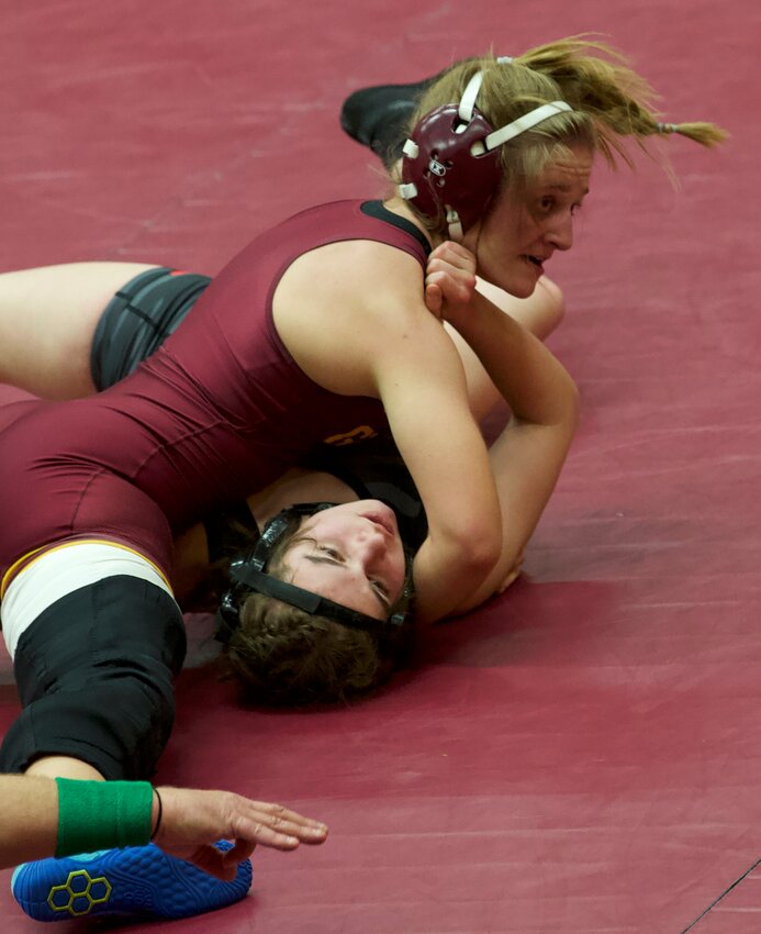 Girard senior Hanna Bailey works toward her second-period pin of Fort Scott&rsquo;s Aubrey Martin during their 125-pound match Thursday at Ted R. Taylor Gymnasium. BROCK SISNEY / THE MORNING SUN